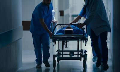 Patient being rushed to surgery on a gurney