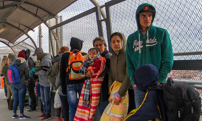 Migrants from Cuba, Venezuela, and Central America queue at the Paso del Norte International Bridge in Ciudad Juarez in Mexico to cross the border and request political asylum in the United States, on January 9.