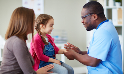 Pediatrician meeting with little girl