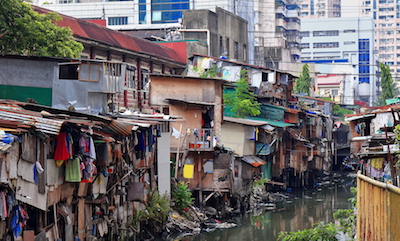 The backs of crowded buildings backing onto a stream in Manila's Chinatown