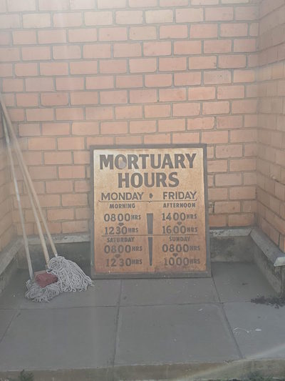 A sign at the Lusaka mortuary says when it is open.