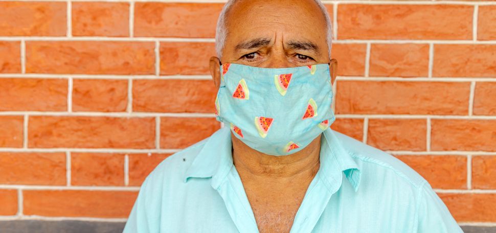 Older man wearing face mask to prevent spread of coronavirus