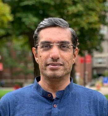 Headshot of man standing in BUSPH green