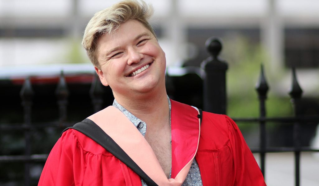 Student smiles at graduation