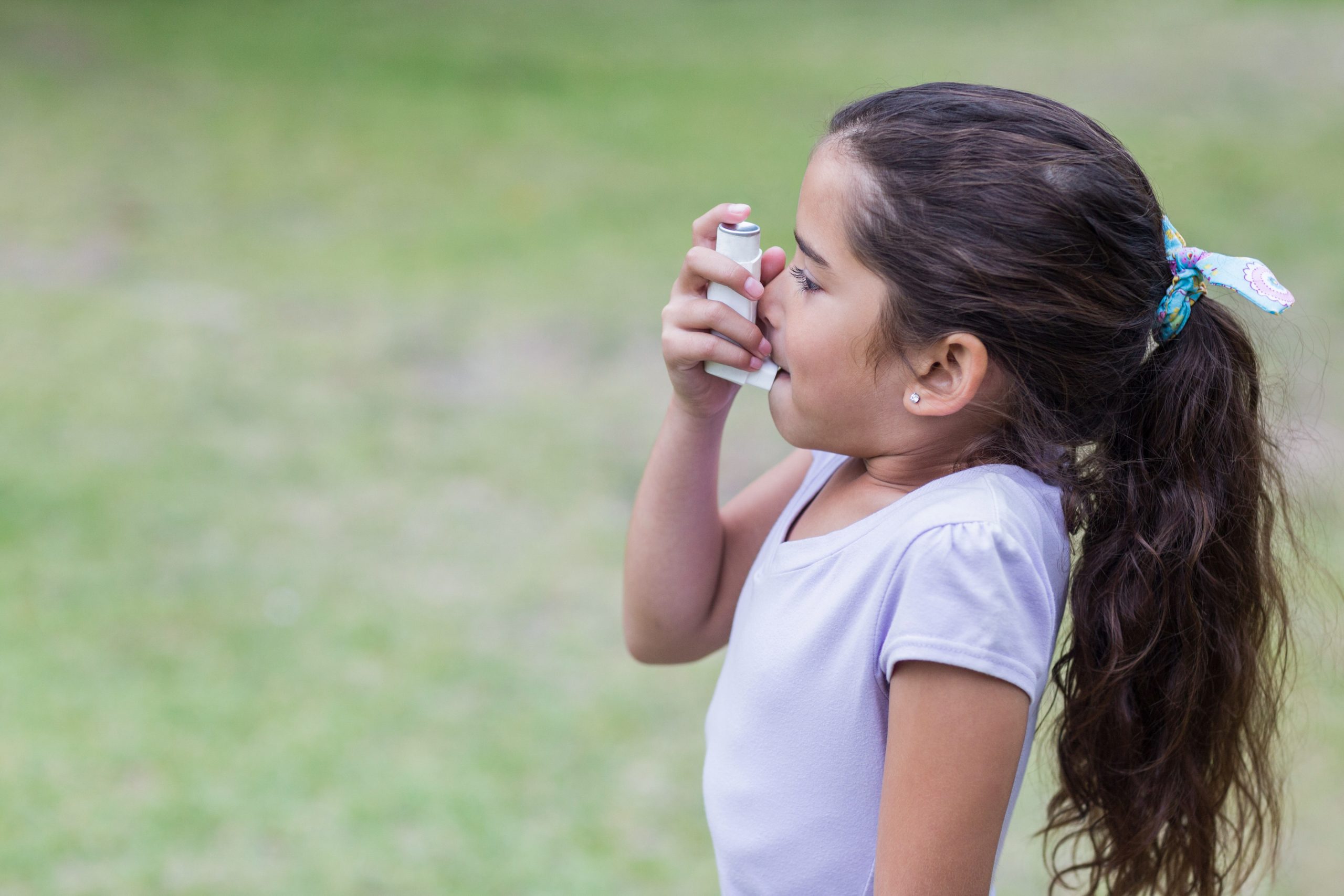 Little girl using inhaler