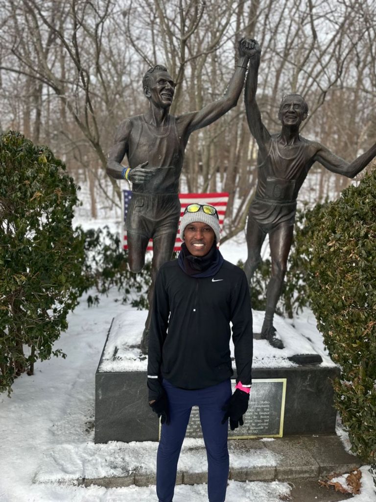 Alex in front of the statue commemorating Boston Marathon legend John Kelley