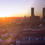 Boston skyline at sunset, BU campus visible in bottom right corner