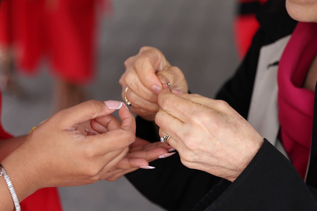 hands adjusting a safety pin