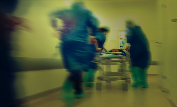 Doctors rushing patient into emergency surgery