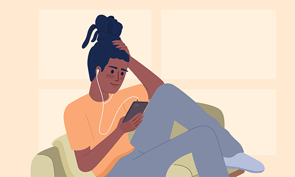 A woman wearing headphones listens to something on her phone.