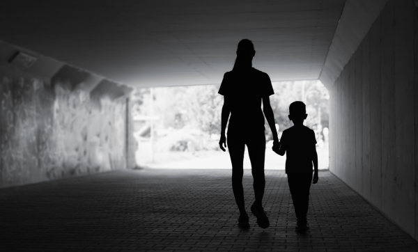 Mother and son walking in the city.
