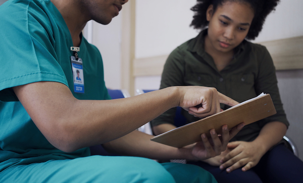 Doctor talk with a patient at hospital. Health and wellness.