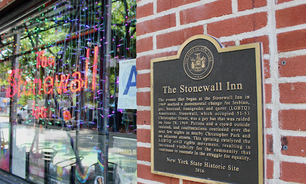 Sign and plaque on the facade of The Stonewall Inn on Christopher Street in Greenwich Village, NYC