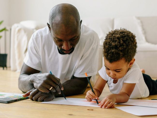 a father and son drawing together