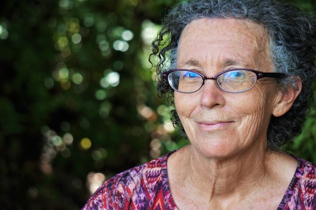 an elderly woman smiling at camera