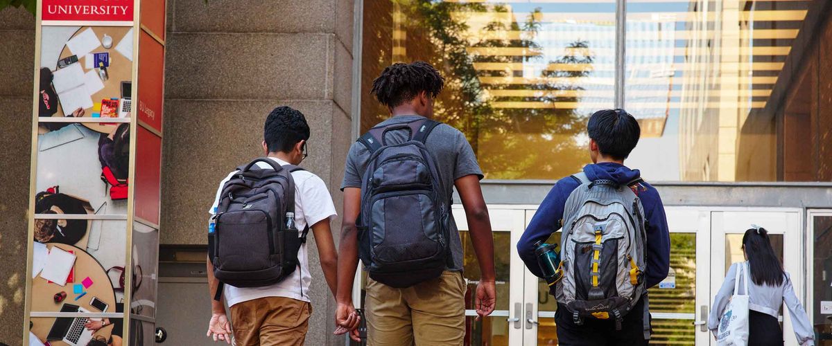 Three students head off to class on Boston University's campus