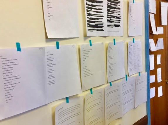 Several students' storyboards taped to the walls of a classroom