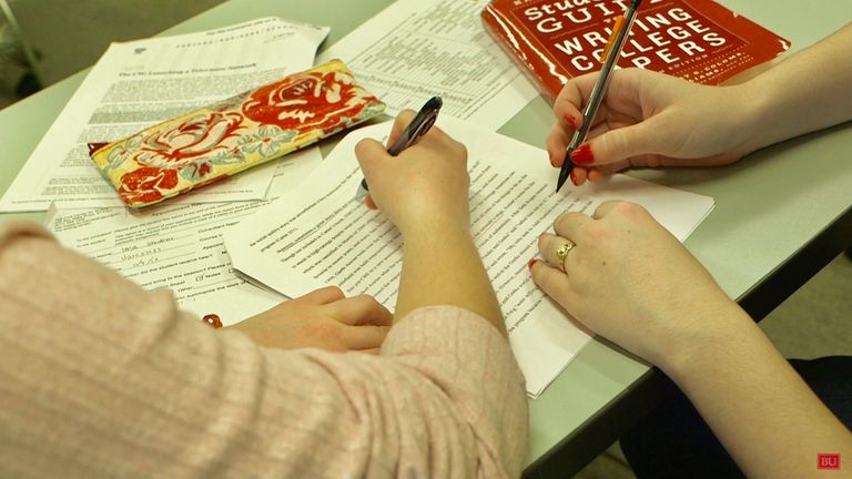 Two students work together on a paper