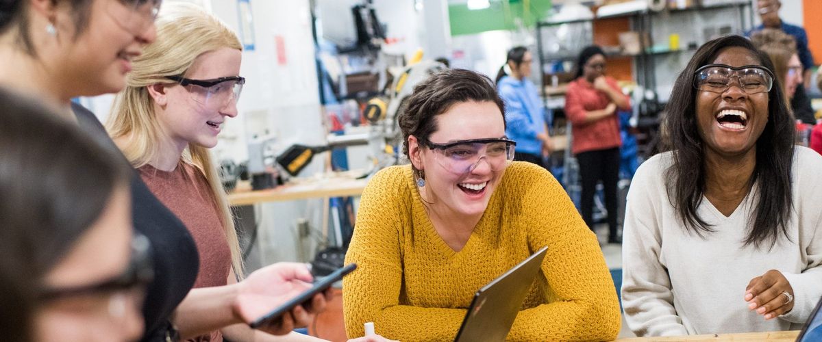 Sargent grad students Grace Hartl (SAR 21) and Tanisha Catule (SAR 21) laugh while working on making a 3-D printed product in the Tinker lab