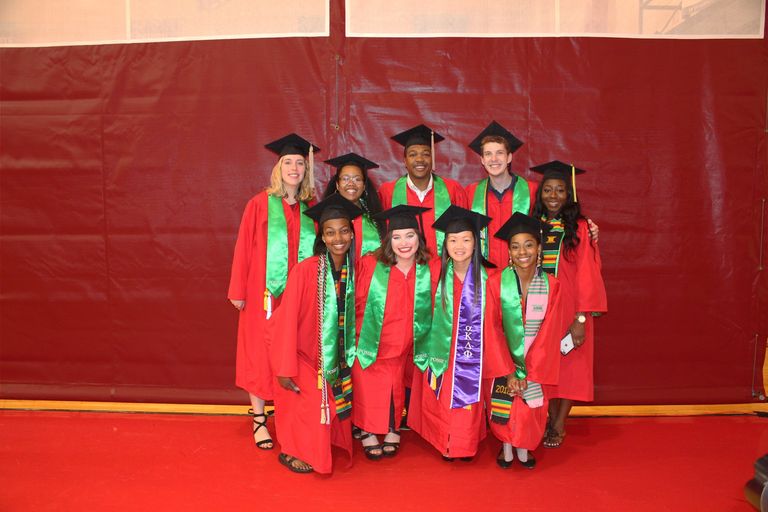 Shows nine recent college graduates in caps and gowns