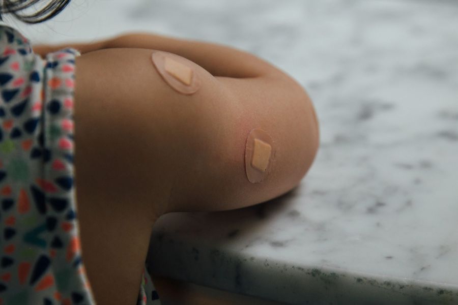 Child arm with bandaid after shot
