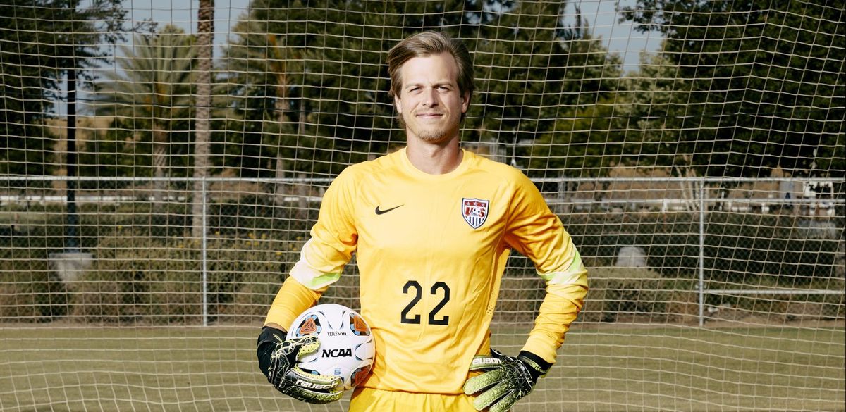 Eric Setzer stands posed infront of soccer goal
