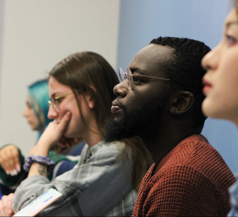 Students look foward listening to professor in class