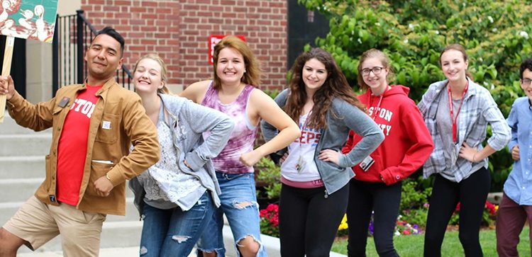Students lined up smiling to camera in Boston Univesity gear