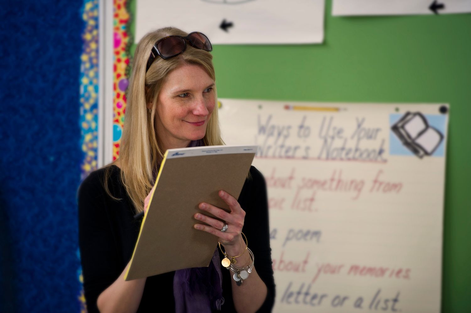 Jennifer Bryson checks in with her students and their pupils during a writing tutoring session at Trotter Elementary School in Dorchester