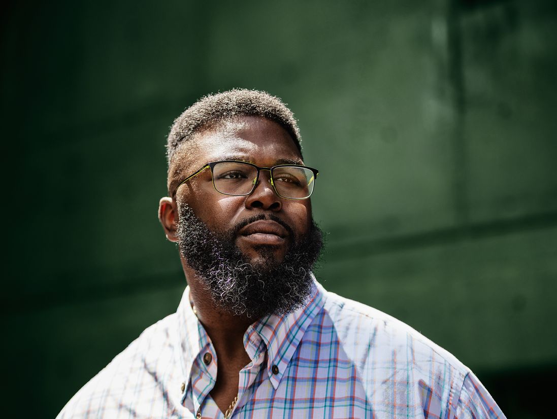 Anthony Jack looking out against green background