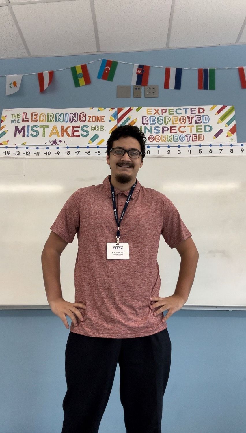 Shows Vincent Semidey standing at the front of a classroom