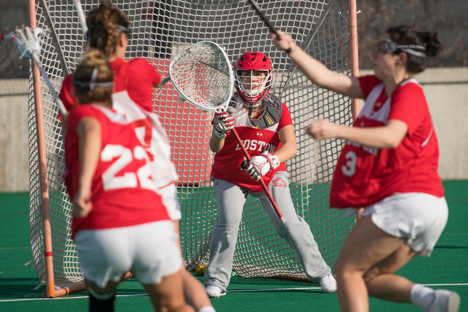 BU women's lacrosse players playing on a field