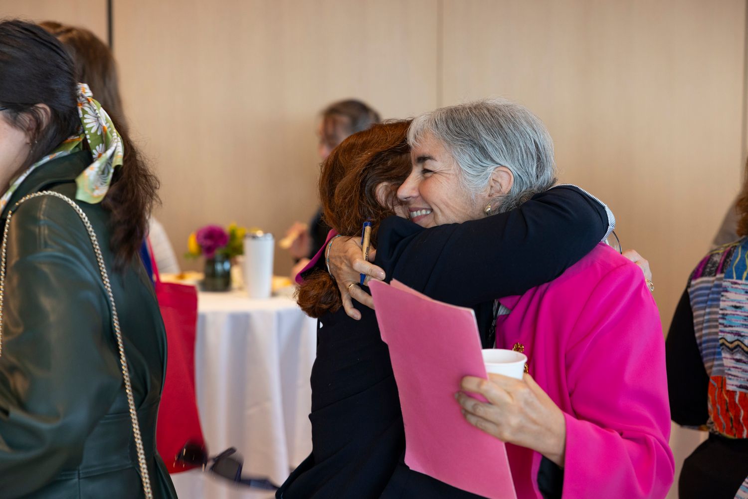 Eleonora Villegas-Reimers hugging Wheelock Alum