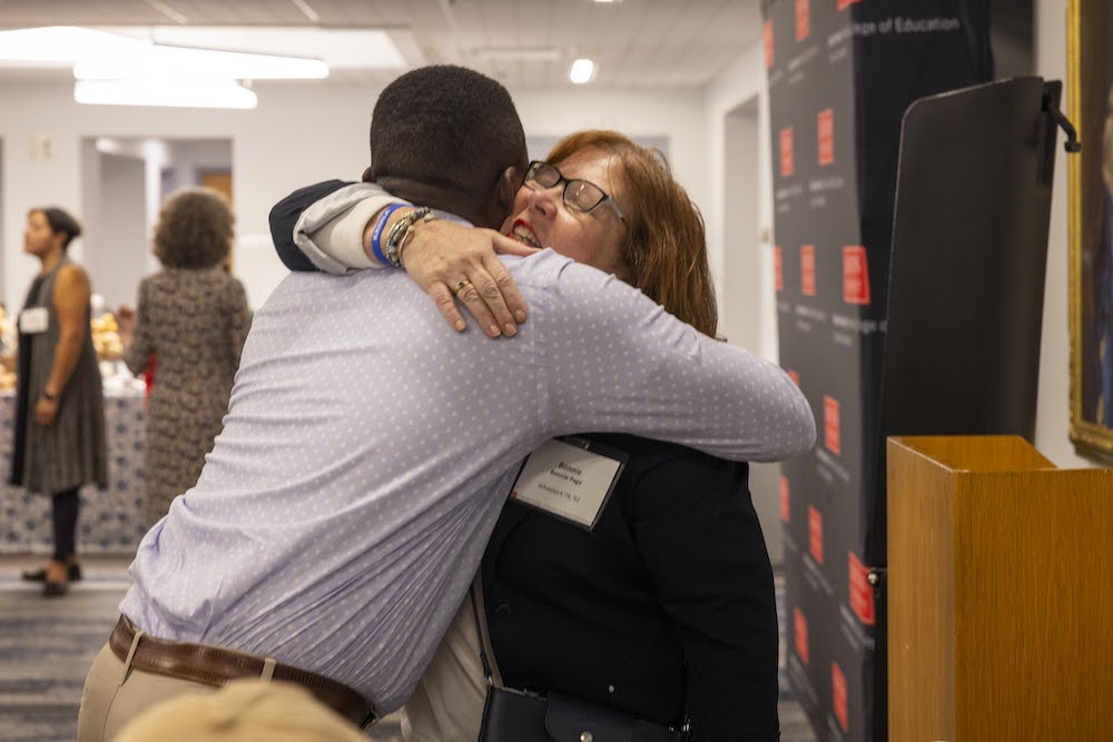 Two Alums hugging at the Lucy Wheelock Tea