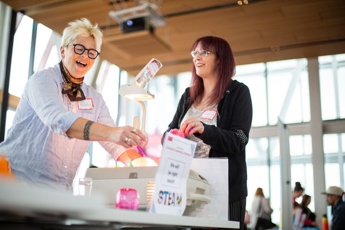 two women smiling over a science demostration