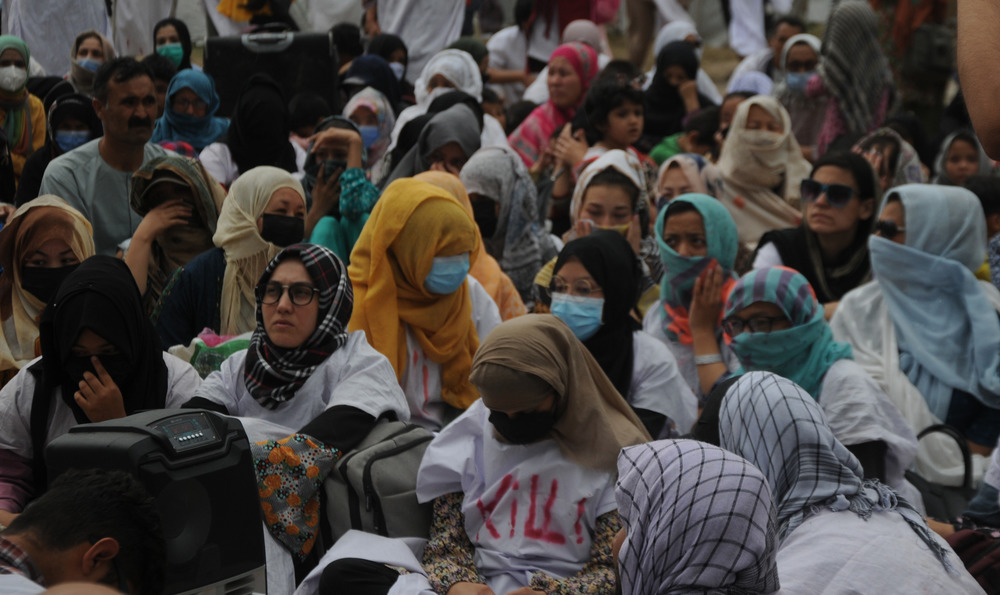 Afghans who fled to Pakistan after the Taliban regained control of Afghanistan last year demand help to seek asylum, during a protest in the Pakistani capital, Islamabad, on 19 May 2022. 