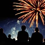 Fireworks display with people watching.