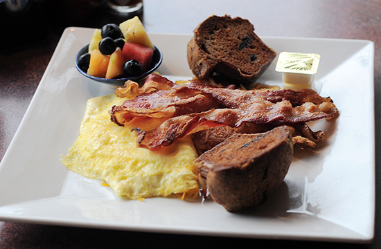 The Baby Blue Breakfast Plate includes an omelet, bacon, home fries, a fruit cup, and muffin—all for under $10.