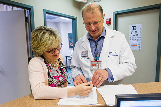 Virginia Gutierrez, manager of the Occupational Health Center, with center medical director Alan Rodgers in medical office