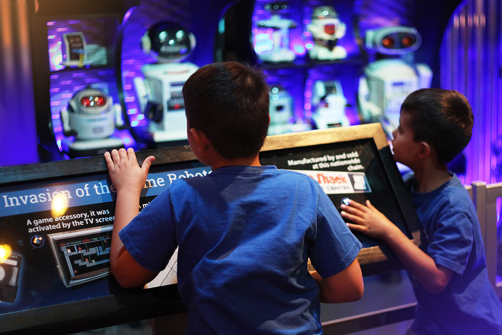 Kids examining robots