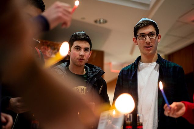 students light candles for Hanukkah