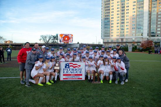 The BU soccer team poses with their Patriots League trophy