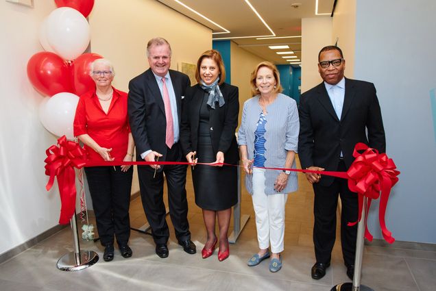 5 people cut the ribbon to celebrate the new home for the Metropolitan College at 1010 Commonwealth Avenue