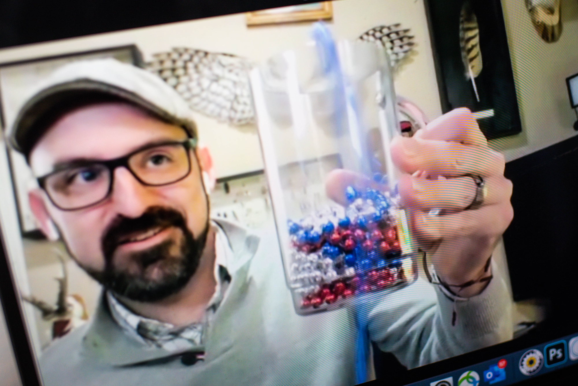 A photo of T.J. McKenna holding up a beaker
