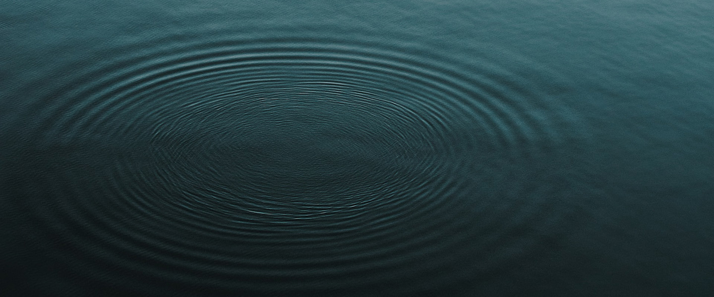 Photo: A dark blue body of water is shown with ripples.