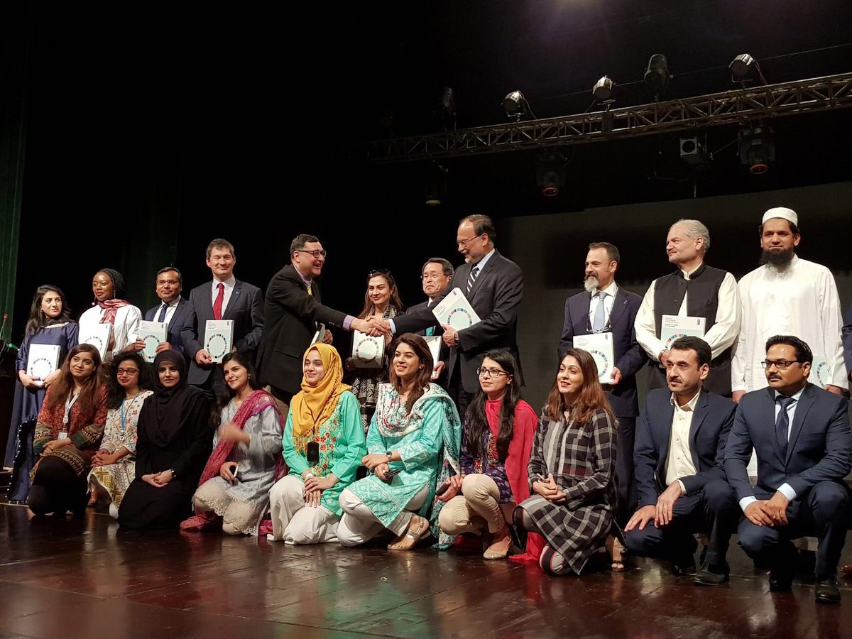 Adil Najam presents a copy of the Pakistan National Human Development Report on Youth to the Minister for Planning and Development, Ahsan Iqbal.