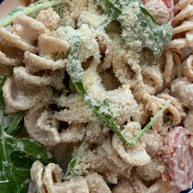 To show the final results of Tahini Parmesan Salad once all ingredients are incorporated.