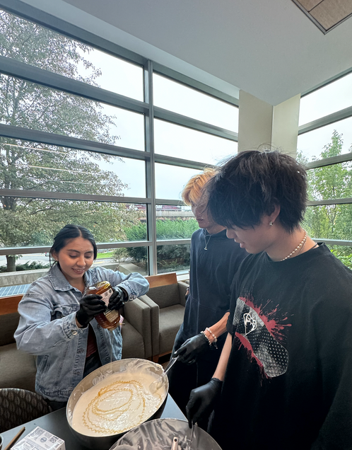 To Show Students working on sweetening the cheesecake mixture.