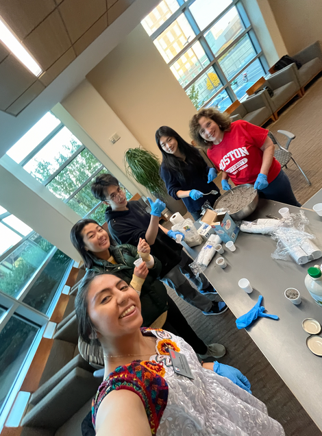 A group of students, and Karen Jacobs, the faculty in staff take a picture while serving the chia seed pudding.