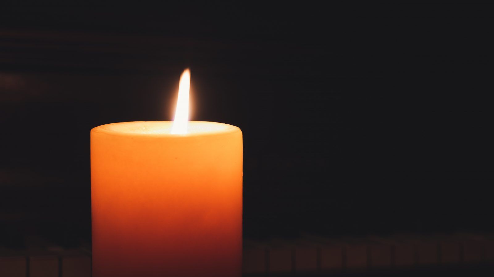 a candle in a dark room